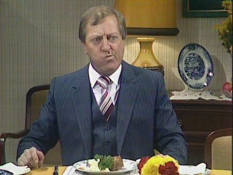 Graham Kennedy pulling a funny face after tasting meatloaf on an episode of Kingswood Country