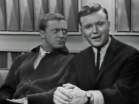 Graham Kennedy looking at Bert Newton who is looking into camera