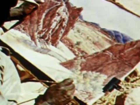 An over-the-shoulder look at Albert Namatjira painting a landscape