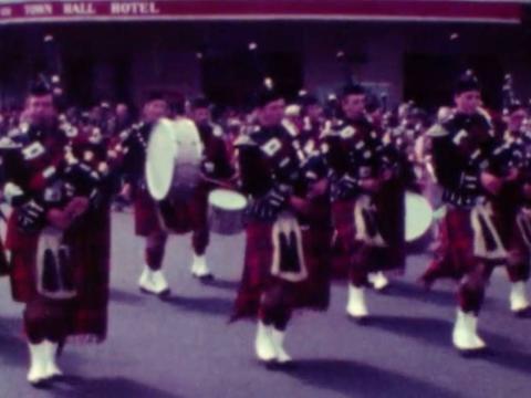 Members of a Scottish marching band performing during an Anzac Day march in 1980