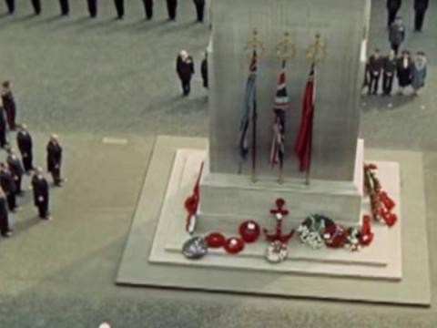 An Anzac memorial surrounded by uniformed members of the armed forces and seen from above during a ceremony
