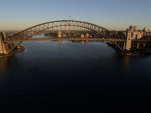 The Sydney Harbour Bridge taken from the air. The blue of Sydney Harbour and the sky look beautiful.
