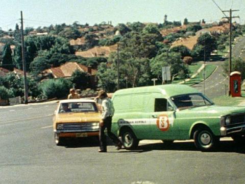 A green panel van and a yellow car involved in a traffic accident on a corner.