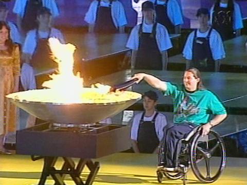 Wheelchair athlete Louise Sauvage is lighting the cauldron at the Sydney 2000 Paralympics. 