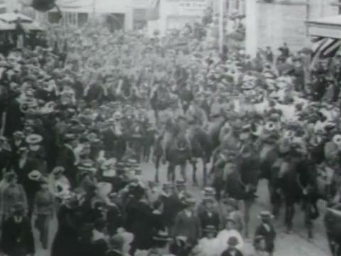 Crowds in Queen Street, Brisbane, watch the First Queensland Cavalry Contingent parade before it departs for the Boer War in South Africa.