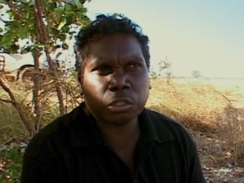 Head and shoulders of an Aboriginal man outdoors