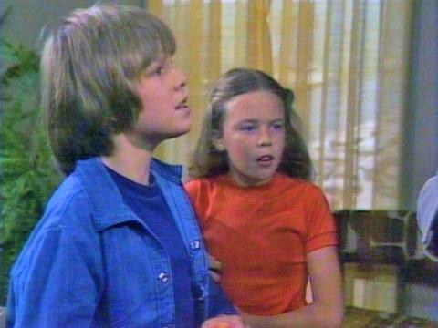 Jason Donovan and Kylie Minogue, pictured from waist up, both aged approximately 8 or 9, in a 1979 episode of the series Skyways. 