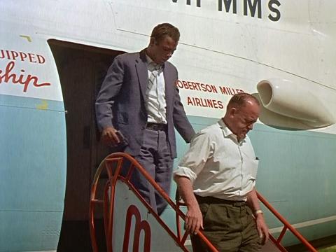 Two men getting of a plane