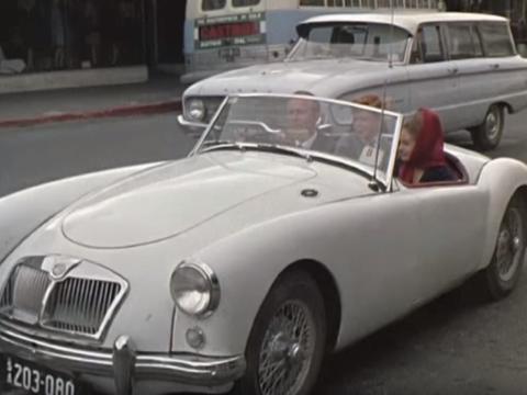 Three young people in a 1960s sports car, in Mount Gambier's main street