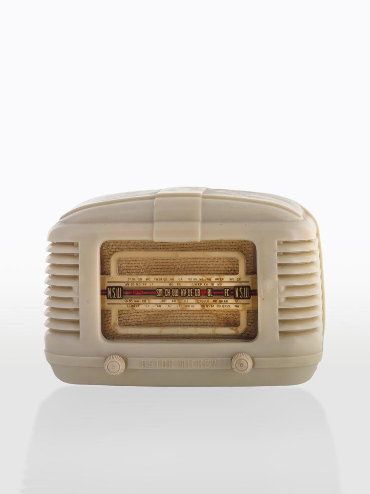 Radio receiver in white plastic casing with dials and display on the front