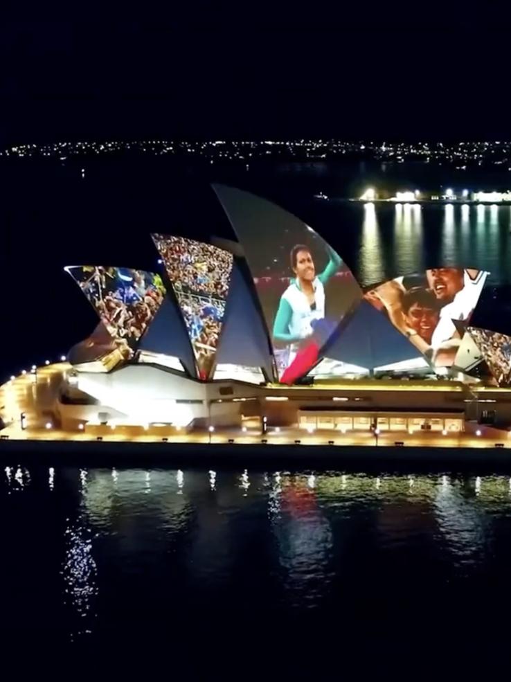 Sydney Opera House at night with the Olympics projected on the roof