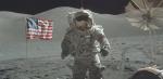 An astronaut standing on the moon with an American flag behind him.