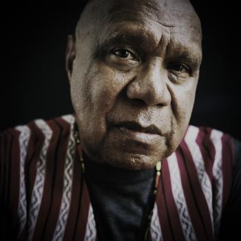 Archie Roach looks at the camera.