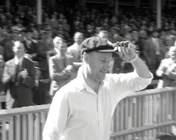 Sir Donald Bradman walks onto the Sydney Cricket Ground ready to bat.