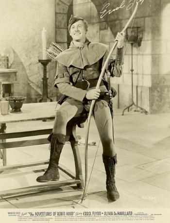 Errol Flynn as Robin Hood seated with bow and arrow