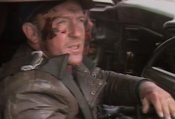 Stuntman Guy Norris seated inside a car.