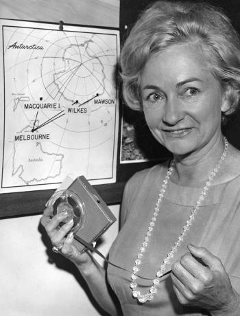 Portrait of Norma Ferris holdng an audio tape next to a map of Antarctica