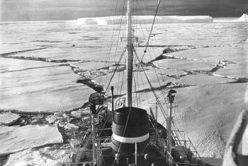 View from the mast looking down on the ship breaking through ice flows.