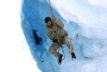 Jarvis attempting to climb out of the crevasse hand over hand