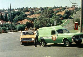 A green panel van and a yellow car involved in a traffic accident on a corner.