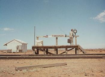 Small, rustic railway platform in a desolate landscape