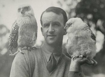 Naturalist David Fleay with a bird on his shoulder and another sitting on his hand
