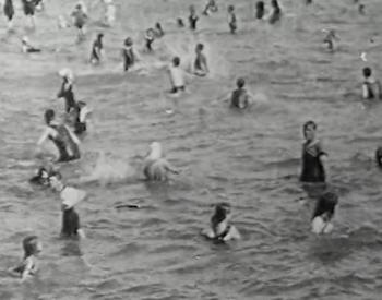 Still frame of people swimming.