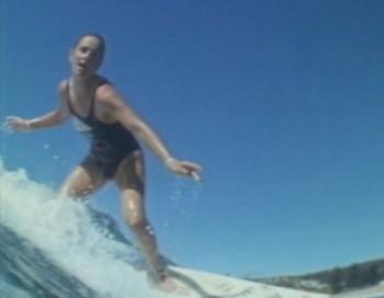 Close up of a woman surfing.