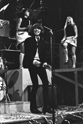 Stevie Wright from The Easybeats with dancing girls in the background.