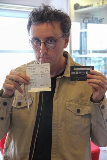Tony Martin holding up a cassette tape and its handwritten cassette cover
