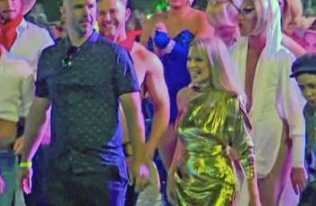 Kylie Minogue in shimmering gold dress walks among the crowd at the Sydney Gay and Lesbian Mardi Gras in 2019