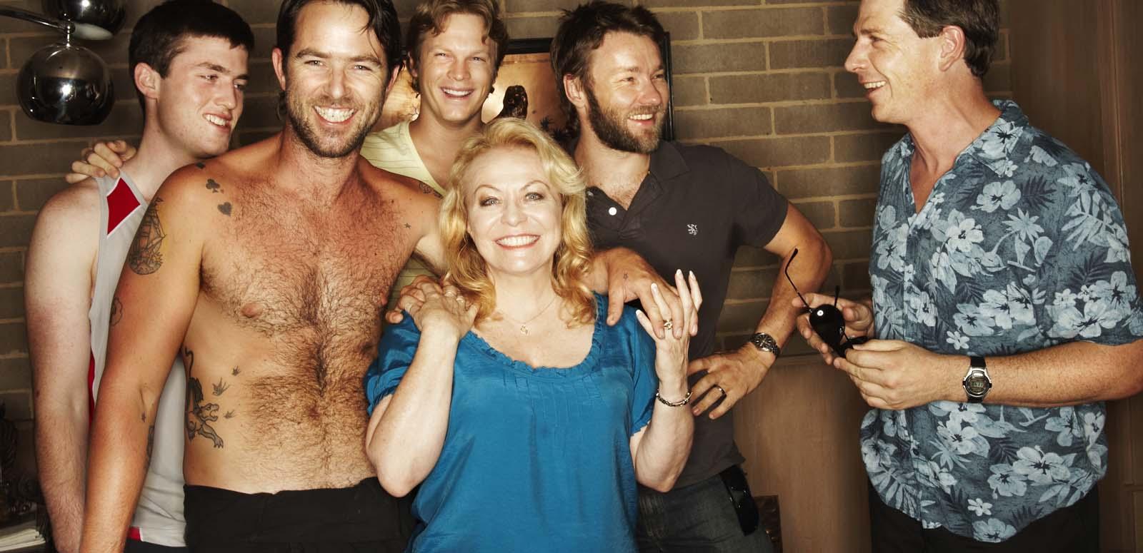 Jacki Weaver and the cast of the film Animal Kingdom laughing together on set
