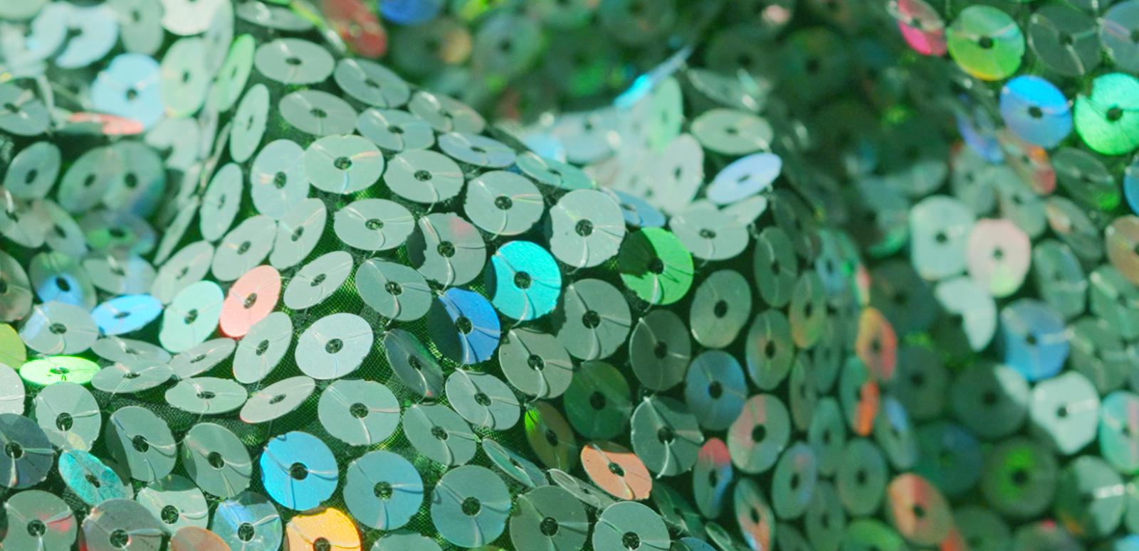 Close up of some green sequinned fabric.