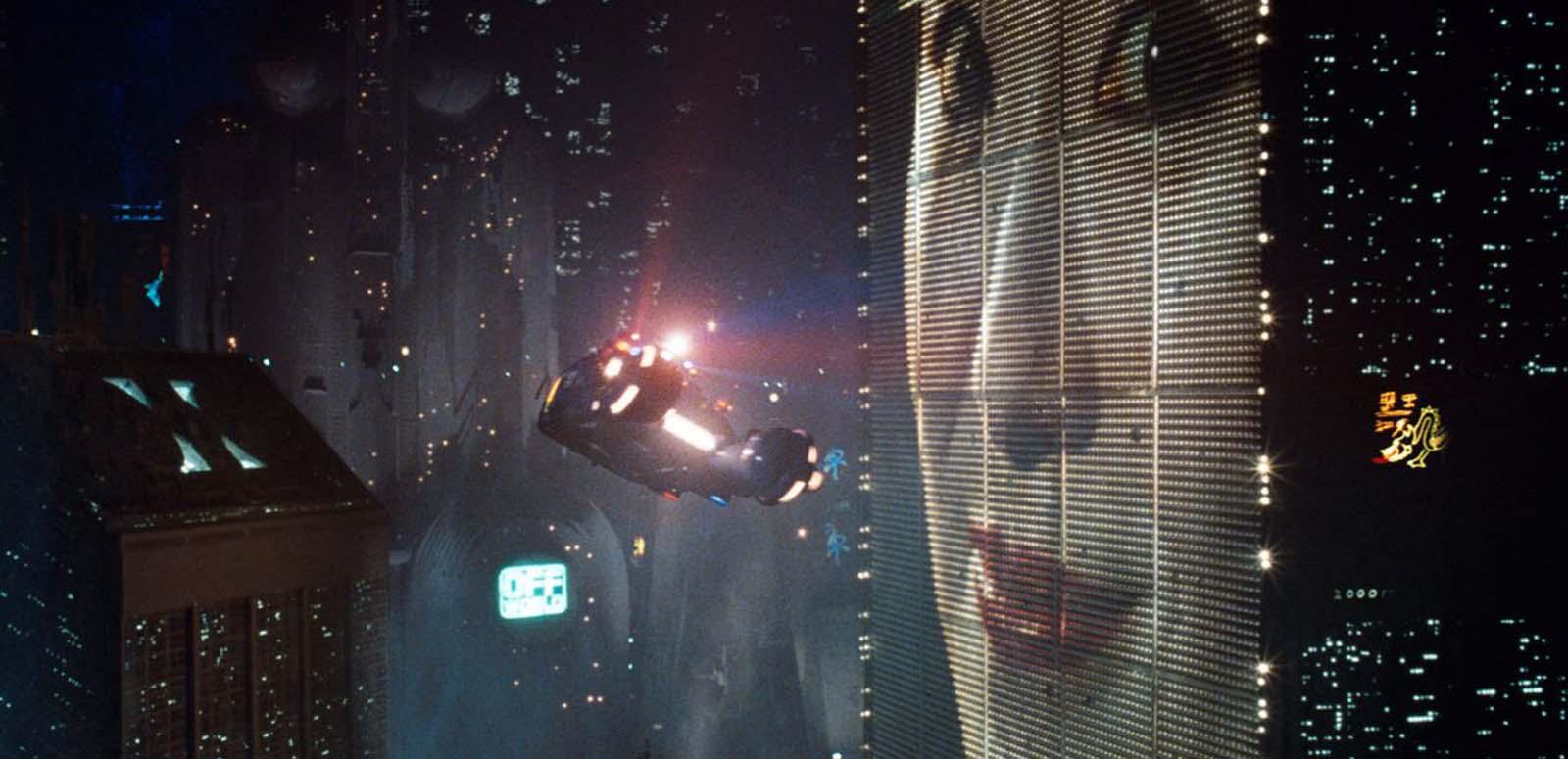 A helicopter hovers in a futuristic neon cityscape beside a giant advertising screen showing a smiling Japanese woman's face