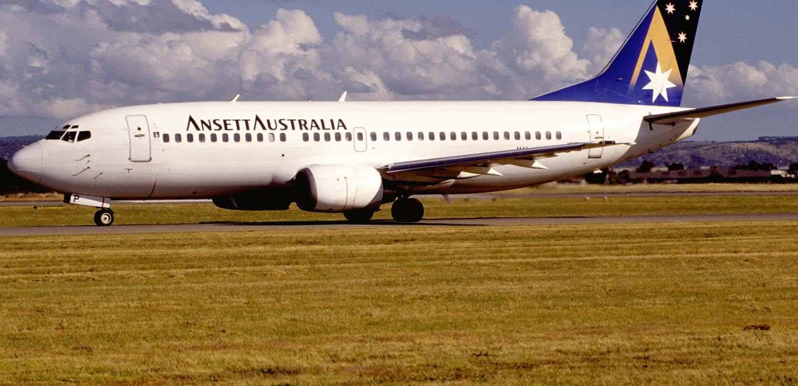 Ansett Australia Boeing 737-300 airplane on a runway on a sunny day