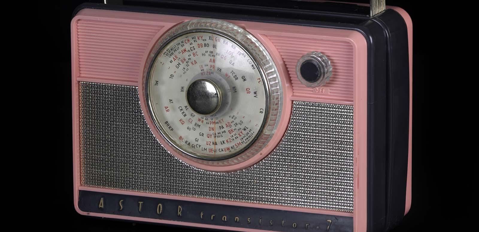 A pink and grey Astor 7 transistor radio from the 1950s or 1960s