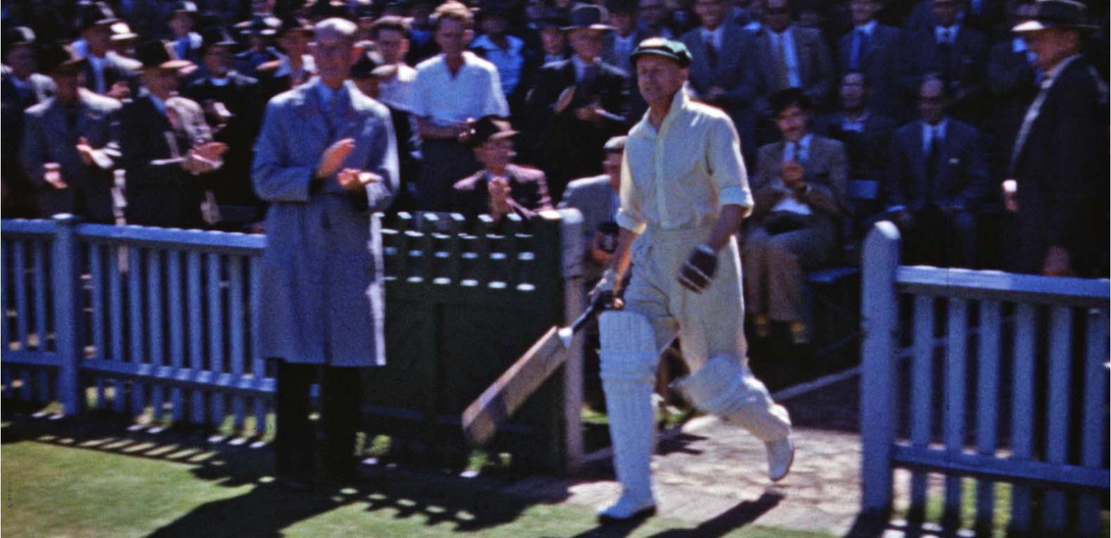 Cricketer Sir Donald Bradman walks onto the Sydney Cricket Ground ready to bat.