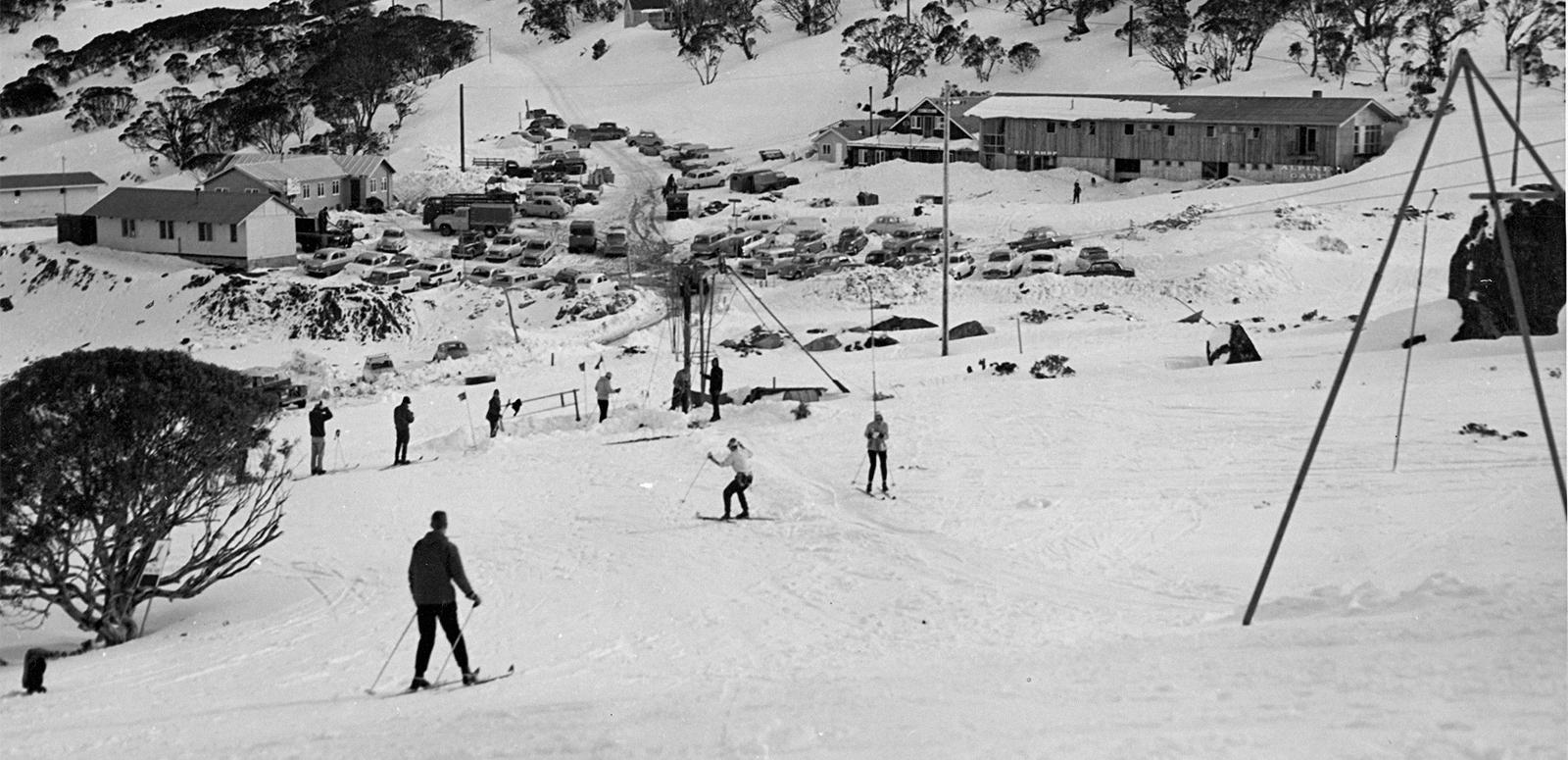 Skiers skiing down a slope in the early 1960s