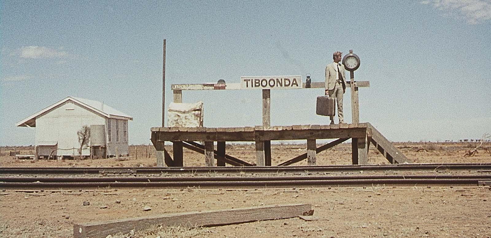 John Grant waits alone on an outback railway station platform in a still from the 1971 film Wake in Fright