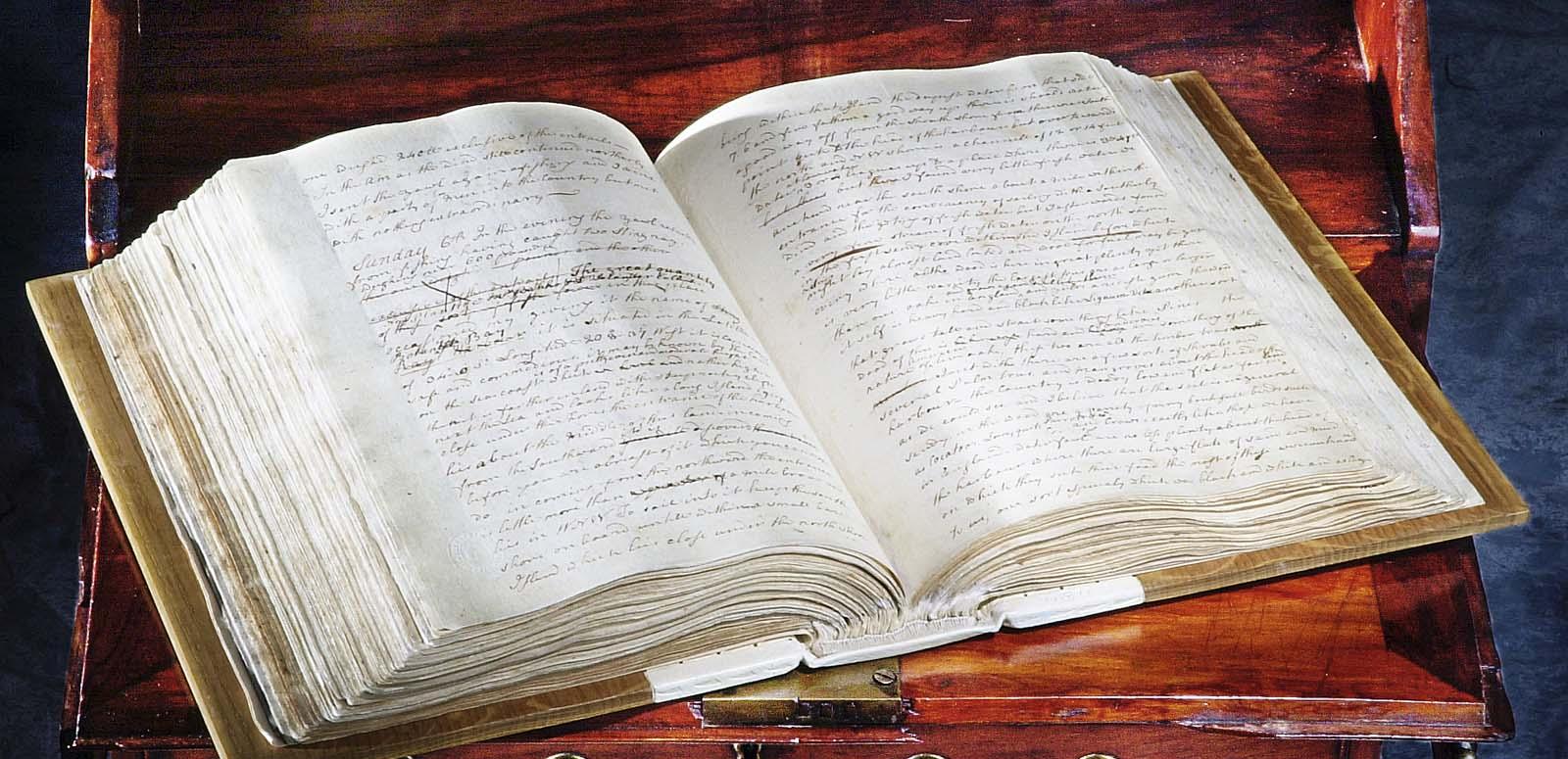 The hardback, handwritten journal of Lieutenant James Cook from 1770, lying open on a table