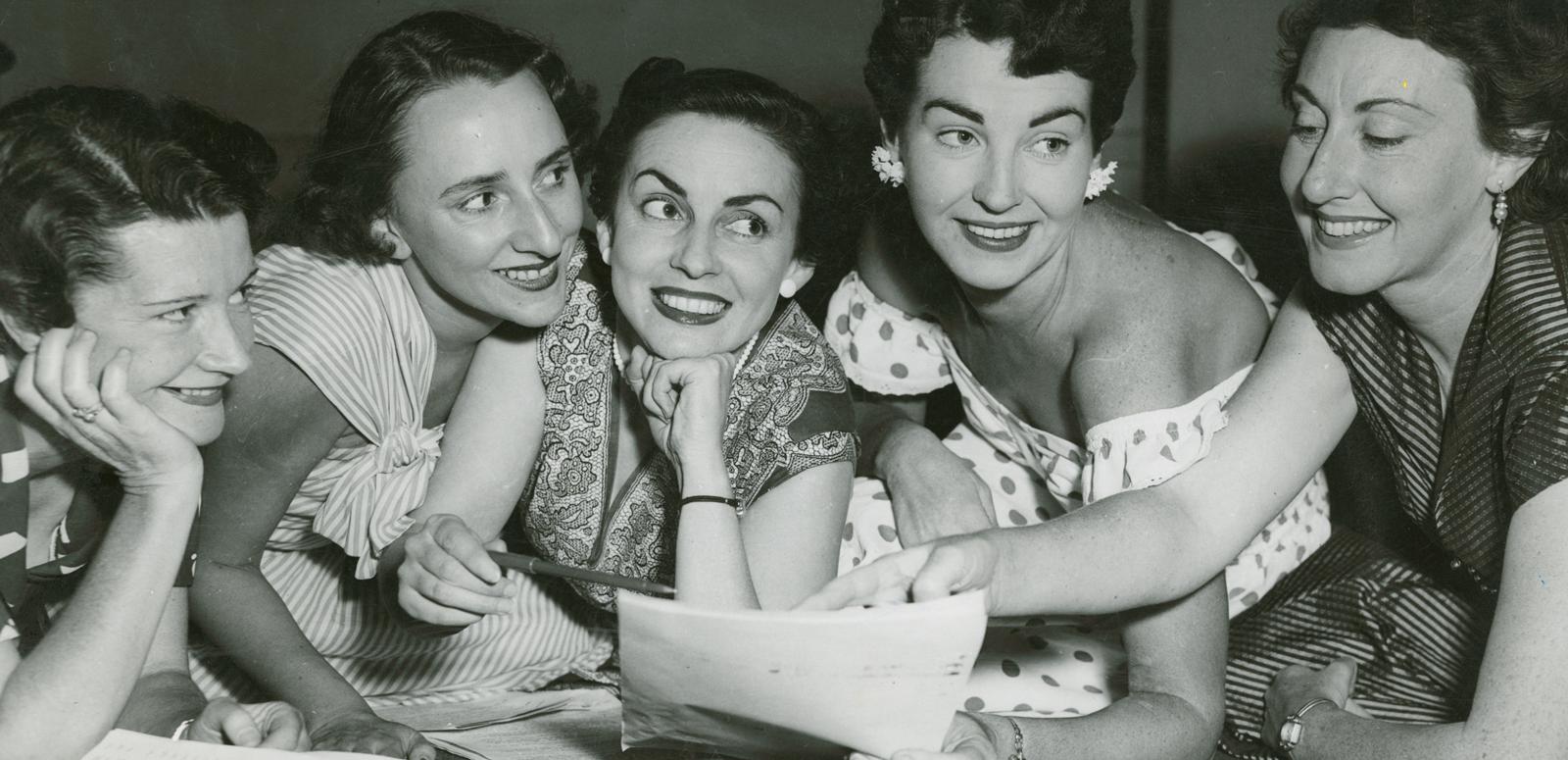 A group of 5 women reading a radio script, circa 1950s.