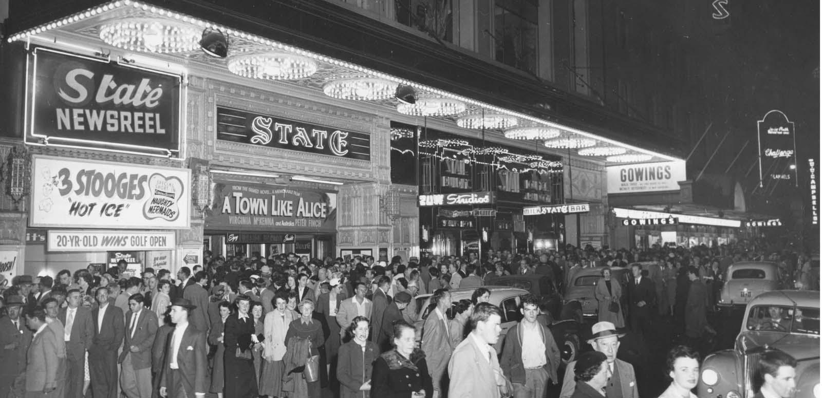 A crowd of patrons in 1950s Sydney outside the State Theatre which is showing A Town Like Alice
