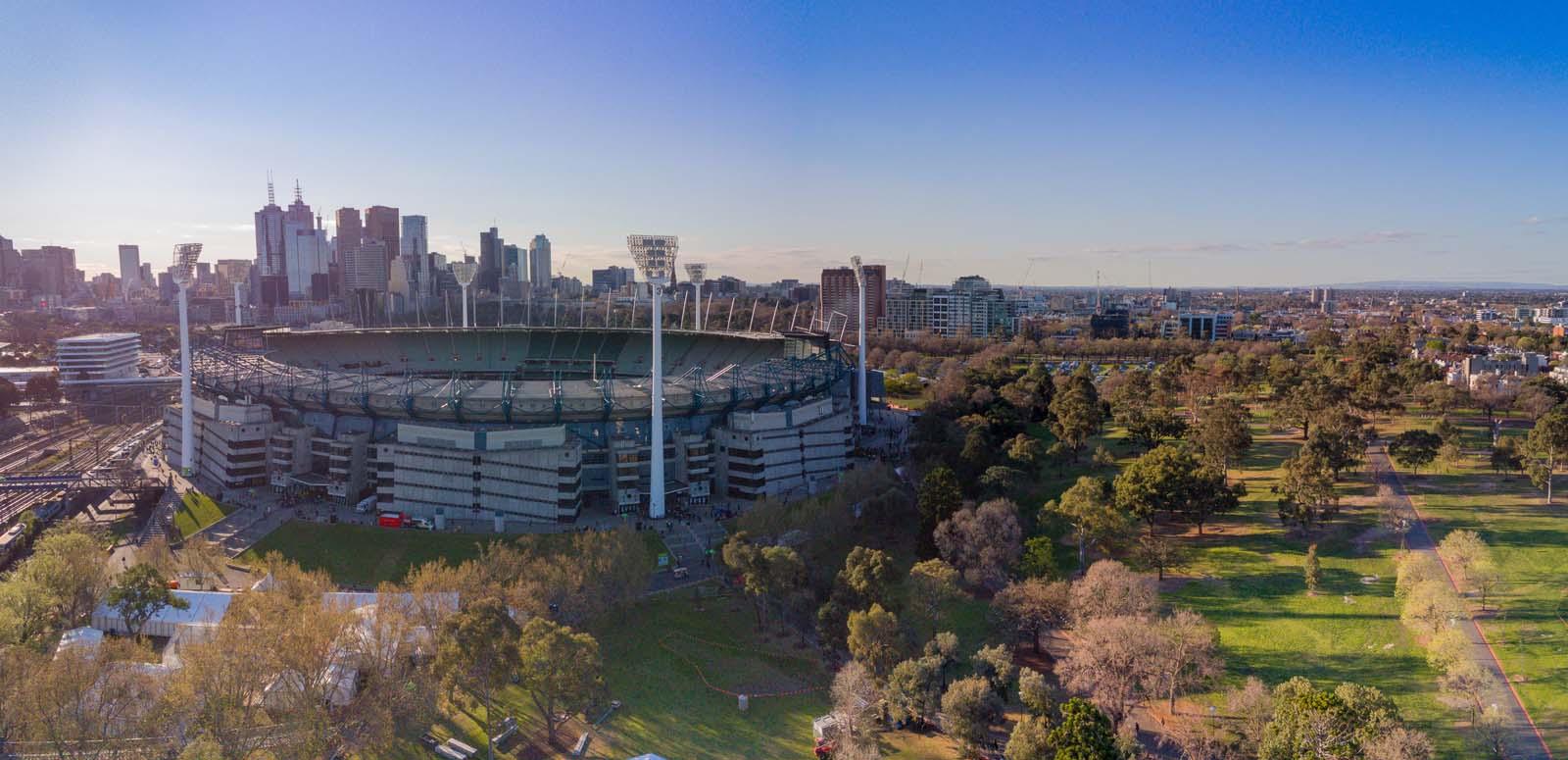 An aerial view of the Melbourne Cricket Ground with the city skyline