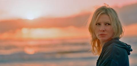 Head and shoulders shot of Cate Blanchett with sun rising in the background from the movie Little Fish. 