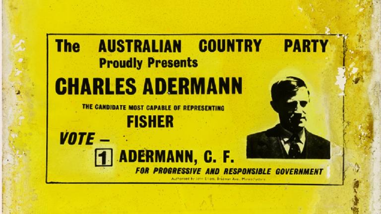 Glass slide comprising yellow background, black text in centre and left with upper body black and white photographic image of Charles Adermann to the right.