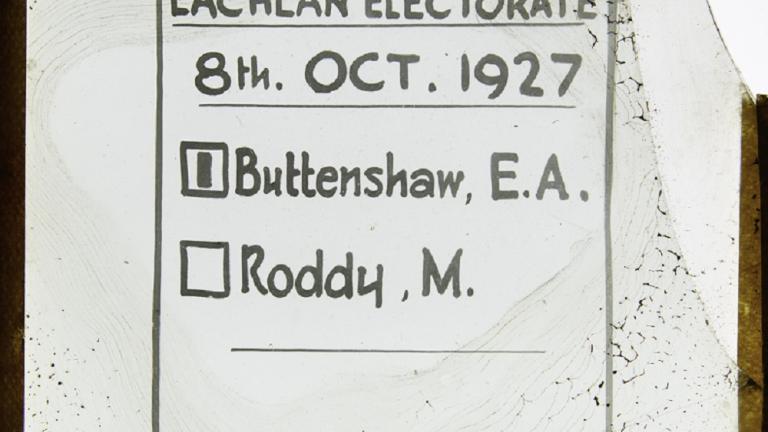 Handwritten glass slide showing ballot paper Clear background with black text. Text: 'Ballot Paper Lachlan Electorate 8th Oct. 1927'. Listed names are [1] Buttenshaw, E.A. and Roddy, M
