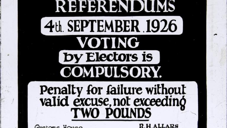 Professionally printed glass slide advertising the newly introduced compulsory voting system. 