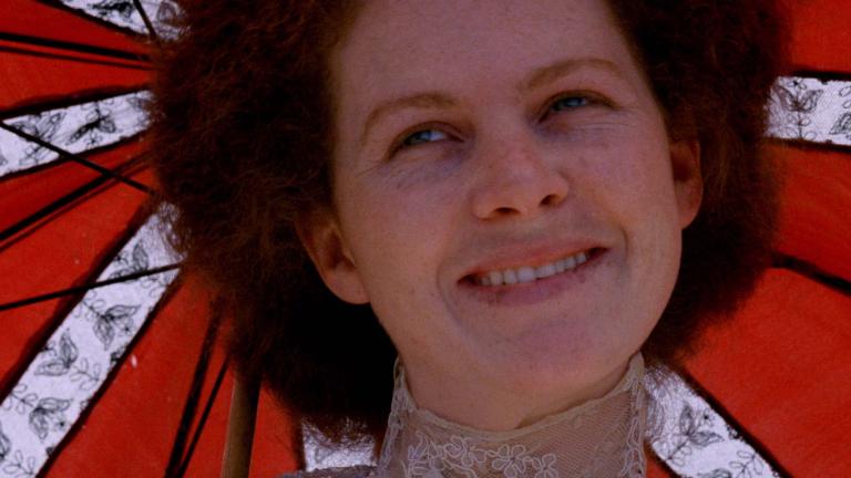 A close-up of Judy Davis smiling under a parasol in My Brilliant Career