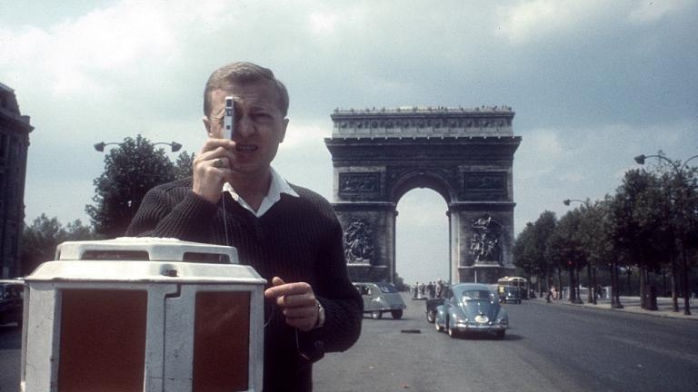 Graham Kennedy taking photos on the Avenue des Champs-Élysées, Paris, with the Arc de Triomphe