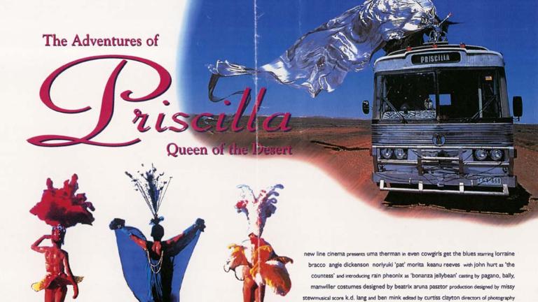 Image of bus travelling across desert with drag queen on top in large, flowing silver costume. Three drag queens in bottom left hand corner.